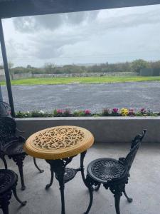 a table and chairs with a view of the water at The Burren Inn in Tubber