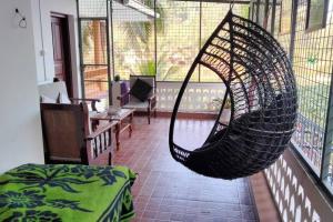 a room with a hammock hanging from a balcony at Ivy Cottage in Mananthavady