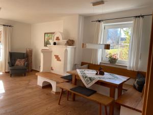 a living room with a table and a window at Chiemgauer Ferienhaus in Siegsdorf