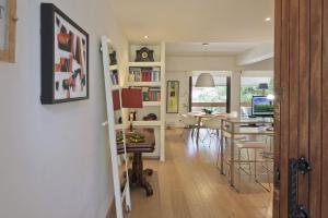 a living room and dining room with a kitchen and a dining table at Sea Breeze Spacious Apt near Vouliagmeni Beach in Athens