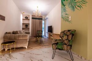 a living room with a couch and a chair at Psyche & Eros Mythical Suites in Athens