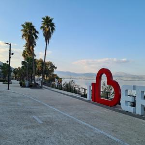 a large red heart sign on the side of a road at על שפת אגם כנרת in Tiberias