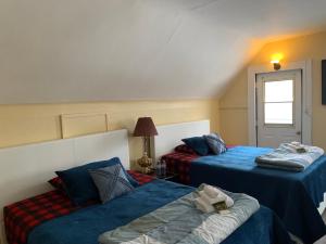 a hotel room with two beds and a window at Marmora and Lake Inn and Victorian Diner in Marmora