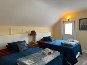 a bedroom with two beds and a window at Marmora and Lake Inn and Victorian Diner in Marmora