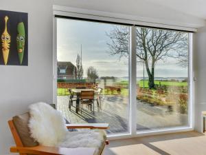 ein Wohnzimmer mit einer großen Glasschiebetür in der Unterkunft Holiday Home Ermelinda - 900m to the inlet in SE Jutland by Interhome in Nordborg