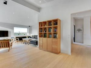 uma sala de estar com uma estante de livros e uma mesa em Holiday Home Ermelinda - 900m to the inlet in SE Jutland by Interhome em Nordborg