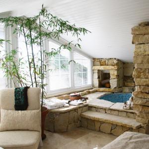 a living room with a stone fireplace and a chair at Lethe Exclusive Hotel in Ağva