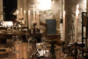 a table with wine glasses and candles on it at Maidla Nature Resort in Maidla