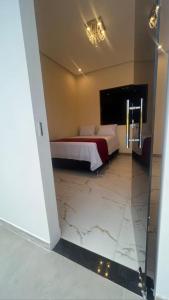 a bedroom with a bed with a marble floor at Casa Diamantina in Ibicoara