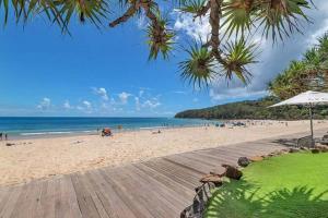 a beach with a wooden boardwalk and the ocean at 617 Hastings Street metres to the beach in Noosa Heads
