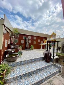 a building with a courtyard with vases on it at Ratanawong Place 552 in Bangkok