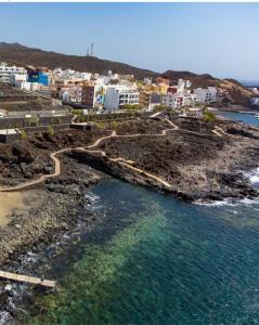 an aerial view of a beach with buildings and the water at APARTAMENTO EL RINCÓN in La Restinga