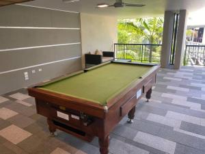 a pool table in the middle of a room at 9311 Fabulous Resort in the Heart of Noosa in Noosa Heads