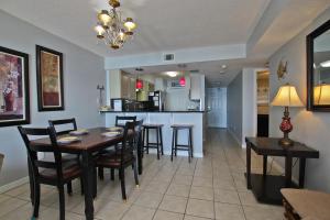 a dining room and kitchen with a table and chairs at Boardwalk 685 in Gulf Shores