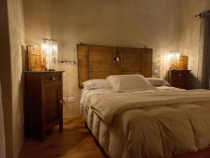 a bedroom with a large bed with a wooden headboard at BeB montefratta in Fratta Terme