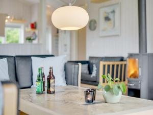 two bottles of beer sitting on a table at Holiday Home Tjakko - 700m from the sea in SE Jutland by Interhome in Neder Lysabild