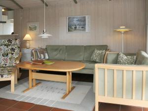 ein Wohnzimmer mit einem Sofa und einem Tisch in der Unterkunft Holiday Home Aasa - 200m from the sea in Western Jutland by Interhome in Fanø