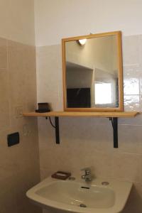 a bathroom with a sink and a mirror at Casa Griot in Pragelato
