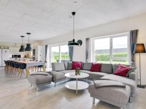 a living room with a couch and a table at Holiday Home Holmsten - 1km from the sea in SE Jutland by Interhome in Neder Lysabild