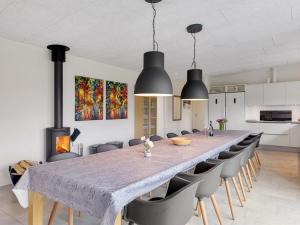 a large dining room with a long table and chairs at Holiday Home Holmsten - 1km from the sea in SE Jutland by Interhome in Neder Lysabild