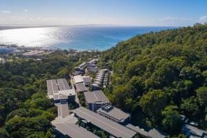 an aerial view of a building and the ocean at 8410 Noosa Sanctuary 2 Bedroom North Facing in Noosa Heads