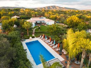 an aerial view of a house with a swimming pool and trees at Seeds of Silence boutique wellbeing hotel near Olhao Faro in Olhão