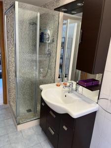 a bathroom with a sink and a shower at Red house in Monteverde - Zen Real Estate in Rome