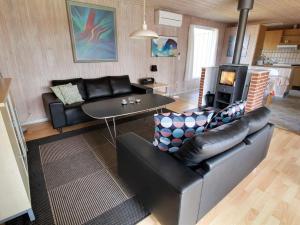 a living room with a couch and a table at Holiday Home Svanhild - 1-2km from the sea in Western Jutland by Interhome in Fanø