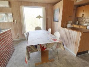 a kitchen with a table and chairs in a room at Holiday Home Svanhild - 1-2km from the sea in Western Jutland by Interhome in Fanø