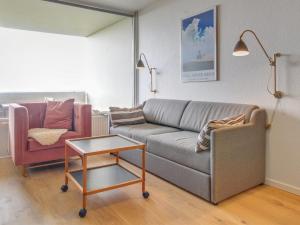 ein Wohnzimmer mit einem Sofa und einem Stuhl in der Unterkunft Apartment Anedorte - 50m from the sea in Western Jutland by Interhome in Fanø