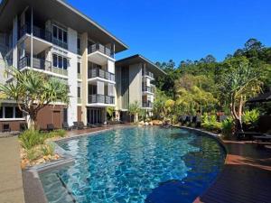 a swimming pool in front of a building at 7211 Lovely 2 Bedroom Viridian Noosa in Noosa Heads