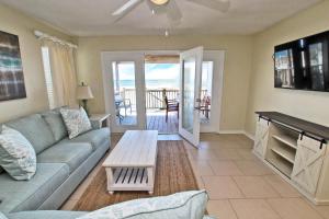 a living room with a couch and a table at Bonhomme Richard East in Gulf Shores