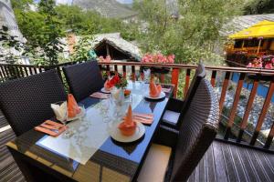a table with plates of food on a deck at Hotel-Restaurant Kriva Ćuprija in Mostar