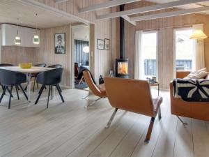 a living room with a table and chairs at Holiday Home Casandra - 600m from the sea in Western Jutland by Interhome in Fanø