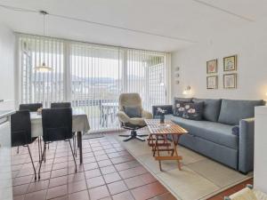 a living room with a couch and a table at Apartment Iliane - 100m from the sea in Western Jutland by Interhome in Fanø