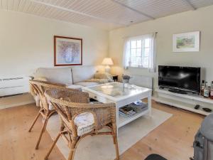 a living room with a couch and a tv at Holiday Home Iivari - 1-5km from the sea in Western Jutland by Interhome in Fanø