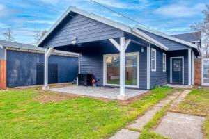 a blue house with a porch and a yard at A Craftsman Bungalow - Walk to UC Davis & Shriners in Sacramento