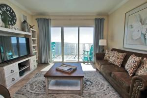 a living room with a couch and a table at Crystal Shores West 1007 in Gulf Shores