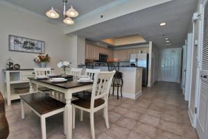 a kitchen and dining room with a table and chairs at Crystal Shores West 1007 in Gulf Shores