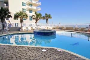 a swimming pool in front of a building with a shark in the water at Crystal Shores West 1007 in Gulf Shores