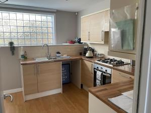 a kitchen with wooden cabinets and a stove top oven at Hot numbers in Cambridge
