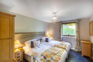 a bedroom with two beds and a window at Lord Galloway 34 with Hot Tub in Newton Stewart