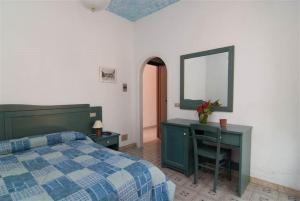 Postel nebo postele na pokoji v ubytování Hotel La Ninfea