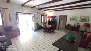 a living room with a table and a dining room at Villa con Piscina Privata fronte Spiaggia in Santa Marinella