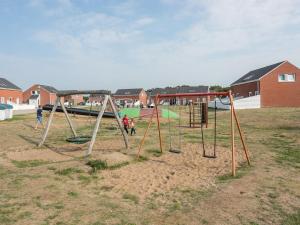 an empty playground with a swing set in a field at Apartment Helvig - 2-3km from the sea in Western Jutland by Interhome in Sønderby