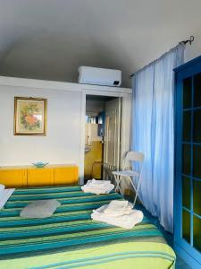 a bedroom with a bed with towels on it at Domus Agricolae Corallina in Torre del Greco