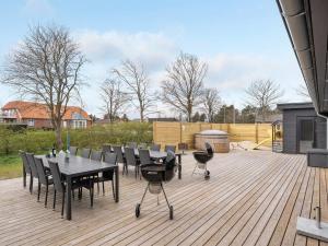 a patio with a table and chairs on a wooden deck at Holiday Home Christiern - 4-5km from the sea by Interhome in Kongsmark