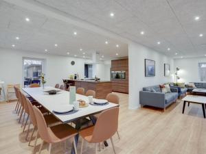 a dining room and living room with a table and chairs at Holiday Home Christiern - 4-5km from the sea by Interhome in Kongsmark