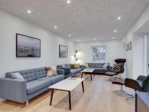 a living room with two couches and a table at Holiday Home Christiern - 4-5km from the sea by Interhome in Kongsmark