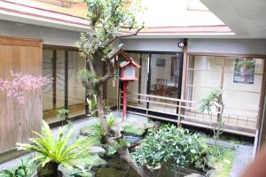 a garden in front of a house with plants at Minshuku Katsuya in Shirahama